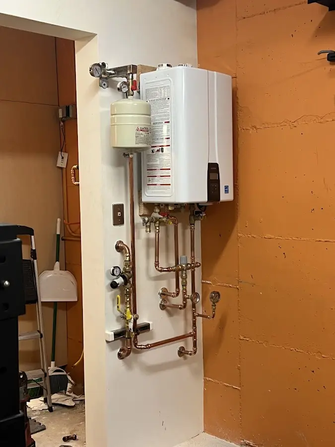 Plumbing technician inspecting water heater connections in Marion Oaks